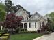 Charming home with stone and siding, front porch, red maple trees, and manicured landscaping at 3300 Magical Pl, Raleigh, NC 27614