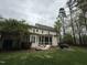 Back of home featuring large screened in porch, brick patio with seating and BBQ at 3300 Magical Pl, Raleigh, NC 27614