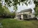 Back of home featuring large screened in porch, brick patio with seating and BBQ at 3300 Magical Pl, Raleigh, NC 27614
