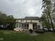 Back of home featuring large screened in porch, brick patio with seating and BBQ at 3300 Magical Pl, Raleigh, NC 27614