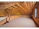 Unfinished attic space with exposed rafters and plywood flooring at 3646 Watkins Farm Rd, Hillsborough, NC 27278
