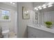 Bright bathroom showcasing a vanity with solid surface counters, a mirror, and a view into the shower-tub area at 3646 Watkins Farm Rd, Hillsborough, NC 27278