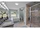 Well-lit bathroom featuring double sinks, soaking tub under a window, and a marble shower, combining luxury and functionality at 3646 Watkins Farm Rd, Hillsborough, NC 27278