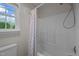 Bathroom showcasing a shower-tub combo, shower curtain, and a window that provides natural light and ventilation at 3646 Watkins Farm Rd, Hillsborough, NC 27278