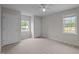 Bright bedroom features neutral paint, carpet, ceiling fan, and double windows, creating a serene and inviting space at 3646 Watkins Farm Rd, Hillsborough, NC 27278