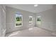 Neutral bedroom offering three windows providing ample natural light, carpeted flooring and neutral colored walls at 3646 Watkins Farm Rd, Hillsborough, NC 27278