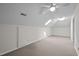 Large bedroom with neutral carpet and several light sources, including overhead and skylights at 3646 Watkins Farm Rd, Hillsborough, NC 27278