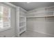 Walk-in closet with white shelving and a window, offering ample storage space and organization at 3646 Watkins Farm Rd, Hillsborough, NC 27278