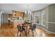 Inviting dining area showcases hardwood floors and a sunlit bay window, perfect for intimate meals or entertaining guests at 3646 Watkins Farm Rd, Hillsborough, NC 27278