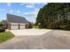 Exterior shot of driveway leading to a two-car garage of brick home with basketball hoop at 3646 Watkins Farm Rd, Hillsborough, NC 27278