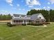 Beautiful two-story brick home with a spacious yard and lush landscaping creating a welcoming and picturesque setting at 3646 Watkins Farm Rd, Hillsborough, NC 27278
