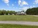 Beautiful home with large manicured front lawn, long driveway, and traditional architectural style at 3646 Watkins Farm Rd, Hillsborough, NC 27278