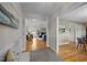 Spacious hallway showcasing hardwood floors and seamless flow into the living room, promoting an airy atmosphere at 3646 Watkins Farm Rd, Hillsborough, NC 27278