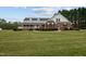 Front exterior showcasing brick facade, white siding, dormers, and inviting front porch at 3646 Watkins Farm Rd, Hillsborough, NC 27278