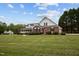 Brick and white siding home exterior featuring a green lawn at 3646 Watkins Farm Rd, Hillsborough, NC 27278