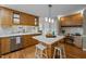 Bright kitchen boasts wooden cabinets, stainless steel appliances, a central island with seating, and a built-in desk area at 3646 Watkins Farm Rd, Hillsborough, NC 27278