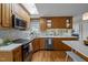 Fully equipped kitchen with stainless appliances, granite countertop, and hardwood flooring, perfect for cooking and entertaining at 3646 Watkins Farm Rd, Hillsborough, NC 27278