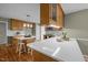 Open concept kitchen boasts granite countertops, custom cabinets, hardwood floors and modern stainless steel appliances at 3646 Watkins Farm Rd, Hillsborough, NC 27278