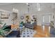 Bright living room with hardwood floors, vaulted ceilings, and an open staircase creates an airy and welcoming atmosphere at 3646 Watkins Farm Rd, Hillsborough, NC 27278