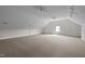 Large loft with neutral carpet and several light sources, including a window at 3646 Watkins Farm Rd, Hillsborough, NC 27278