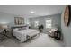 Spacious main bedroom with a seating area, two windows for natural light, and soft blue walls, creating a relaxing retreat at 3646 Watkins Farm Rd, Hillsborough, NC 27278