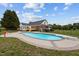 Backyard view of pool, diving board, and deck surrounded by lawn, landscaping, and a fence at 3646 Watkins Farm Rd, Hillsborough, NC 27278