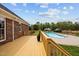 Inviting back deck overlooking the refreshing in-ground pool and well-manicured lawn at 3646 Watkins Farm Rd, Hillsborough, NC 27278