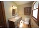 This bathroom features a vanity with granite countertops, a cabinet, and a toilet at 3813 W West Lake Rd, Apex, NC 27539