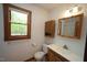 Bathroom featuring double sinks, a medicine cabinet, and a toilet at 3813 W West Lake Rd, Apex, NC 27539