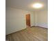 This bedroom offers wood-look flooring, natural light from a window, and neutral walls at 3813 W West Lake Rd, Apex, NC 27539