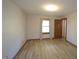 This bedroom offers wood-look flooring, natural light from a window, and neutral walls at 3813 W West Lake Rd, Apex, NC 27539