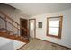 Bright entryway featuring wood-look floors, staircase, and decorative front door at 3813 W West Lake Rd, Apex, NC 27539