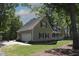 Exterior view of home with a two-car garage and lush green yard at 3813 W West Lake Rd, Apex, NC 27539