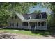 Charming home featuring a welcoming front porch and beautifully landscaped yard at 3813 W West Lake Rd, Apex, NC 27539