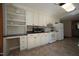 Kitchen featuring white cabinets, modern appliances, and tile flooring at 3813 W West Lake Rd, Apex, NC 27539