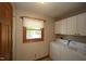 Laundry room with washer, dryer, and cabinets at 3813 W West Lake Rd, Apex, NC 27539