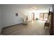 Spacious living room featuring wood-look floors, ceiling fan, and a door to the backyard at 3813 W West Lake Rd, Apex, NC 27539