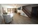 Cozy living room featuring a fireplace, wood-look floors, and staircase at 3813 W West Lake Rd, Apex, NC 27539