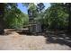 Detached outbuilding with a covered porch and surrounded by mature trees at 3813 W West Lake Rd, Apex, NC 27539