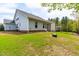 Spacious backyard featuring a well-maintained lawn, fenced perimeter, and screened-in porch at 408 Price Lake Way, Fuquay Varina, NC 27526