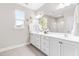 Bright bathroom features double sink vanity, white cabinets, large mirror and decorative star accents at 408 Price Lake Way, Fuquay Varina, NC 27526