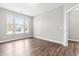 A sunlit bedroom with wood-look flooring and neutral walls showcasing a tranquil space at 408 Price Lake Way, Fuquay Varina, NC 27526