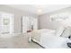 Carpeted bedroom with access to a bathroom and plenty of natural light at 408 Price Lake Way, Fuquay Varina, NC 27526