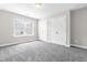 Bright bedroom with plush carpeting, double closets, and a sunlit window offering pleasant views at 408 Price Lake Way, Fuquay Varina, NC 27526