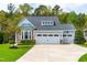 Charming home featuring a three-car garage, stone accents, and a well-manicured lawn at 408 Price Lake Way, Fuquay Varina, NC 27526