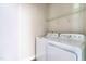 Efficient laundry room with a side-by-side washer and dryer, plus wire shelving for storage at 408 Price Lake Way, Fuquay Varina, NC 27526