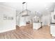 Open-concept living space featuring a kitchen with island and hardwood floors at 408 Price Lake Way, Fuquay Varina, NC 27526