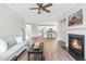 Spacious living room with fireplace and hardwood floors open to the kitchen at 408 Price Lake Way, Fuquay Varina, NC 27526