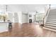 Open-concept living room featuring hardwood floors, fireplace, and a staircase, perfect for entertaining at 408 Price Lake Way, Fuquay Varina, NC 27526