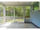 Relaxing screened-in porch with views of the lush backyard, offering a serene outdoor living space at 408 Price Lake Way, Fuquay Varina, NC 27526